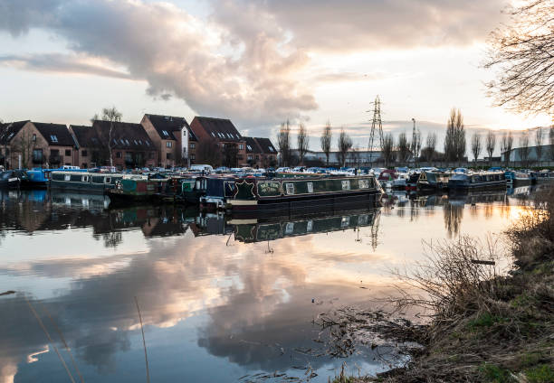 Canal boats moored at Castle Marina in Nottingham during sunset.