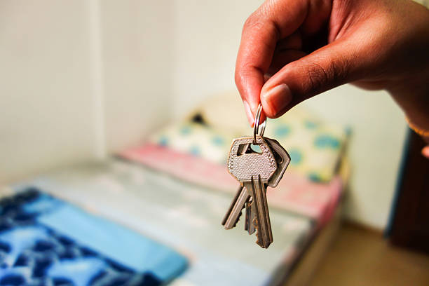 Holding room house keys giving renting