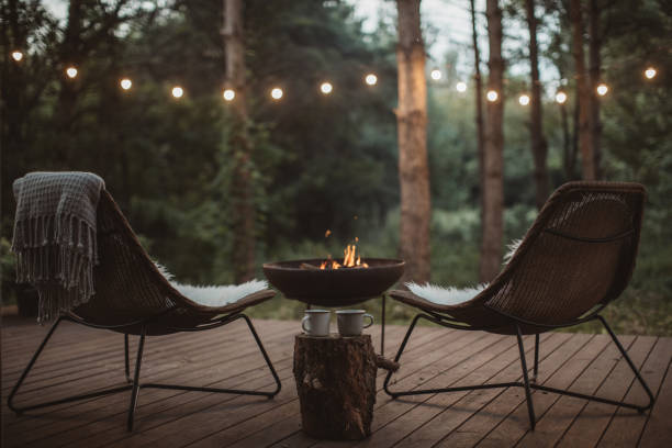 Cottage porch with two cozy chairs on it and fireplace